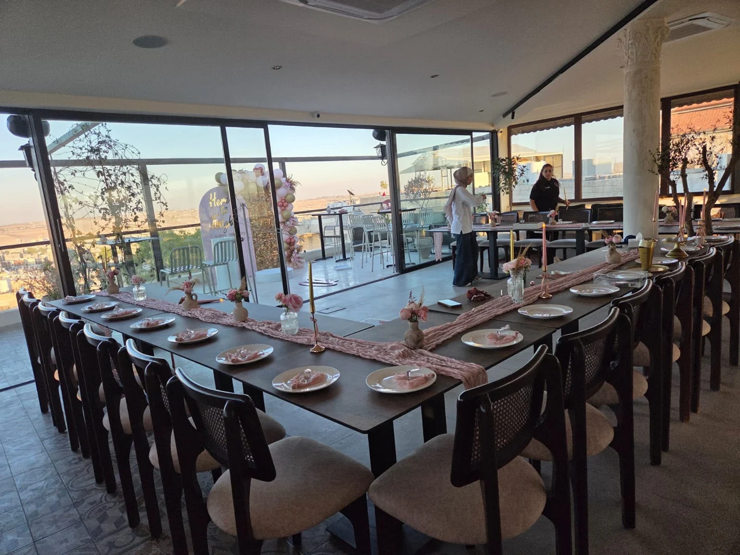 Decorated celebration tables with flowers, candles and place settings at Saint John Hotel in Madaba