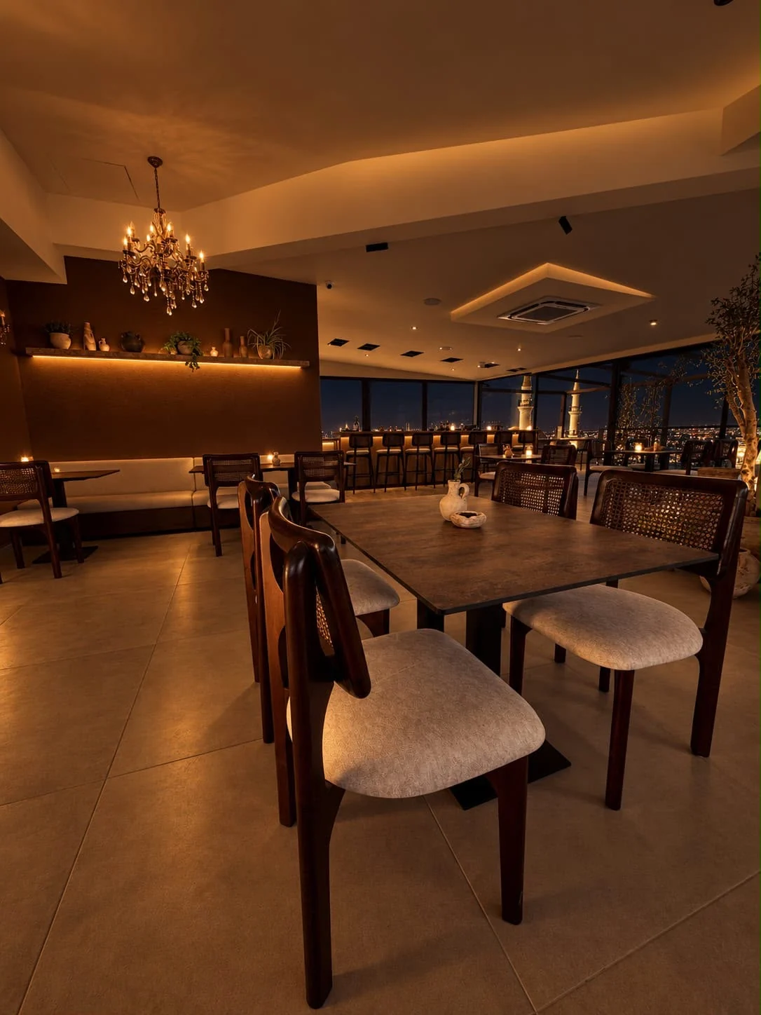 Warm evening lighting and dining tables at Saint John’s rooftop event venue in Madaba