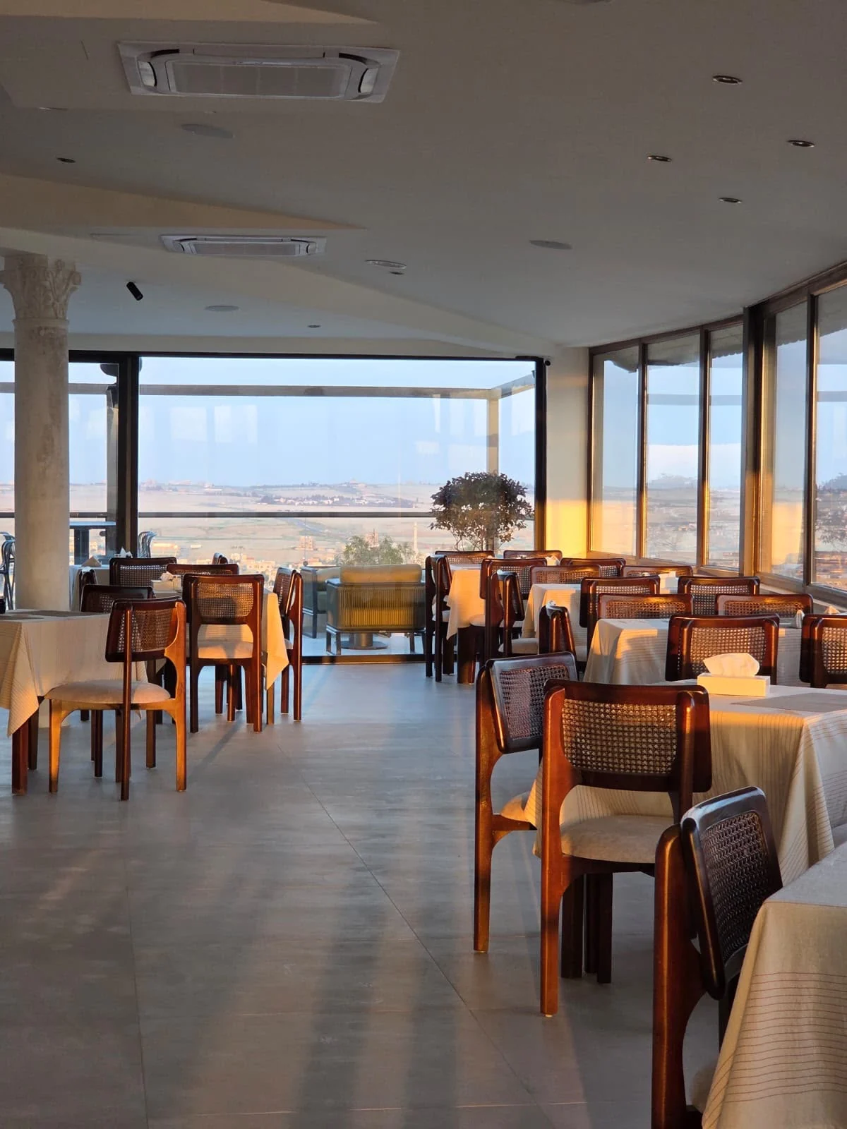 Sunlit rooftop restaurant tables for a family celebration in Madaba