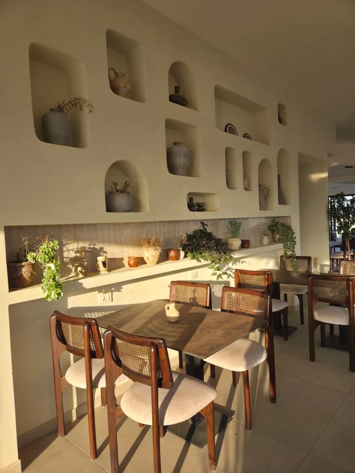 Dining tables and decorative details inside Saint John Hotel’s restaurant